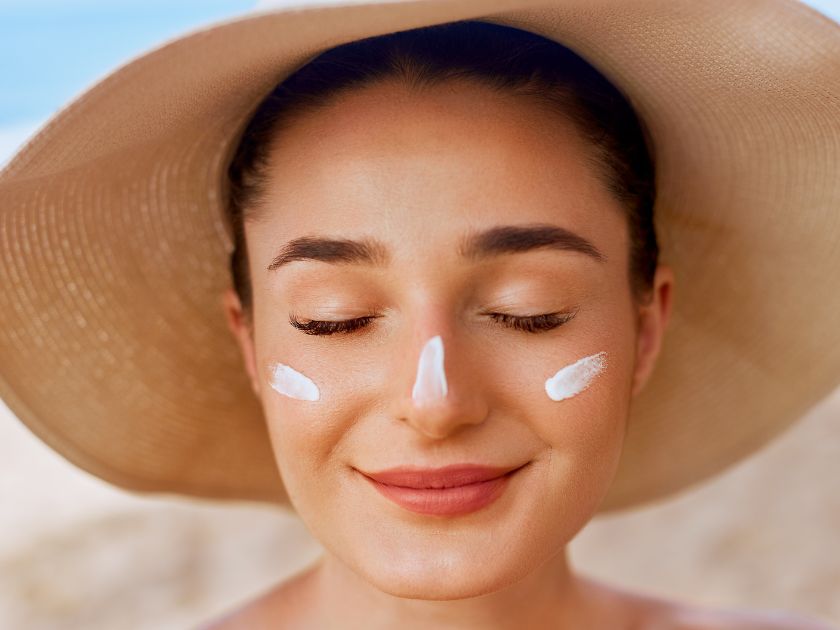 Woman with reef-safe sunscreen on face