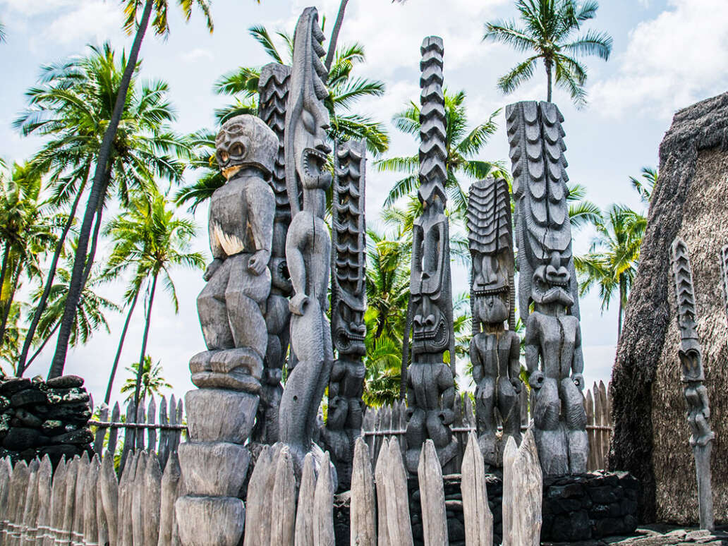 Statues greet visitors to Puuhonua O Honaunau
