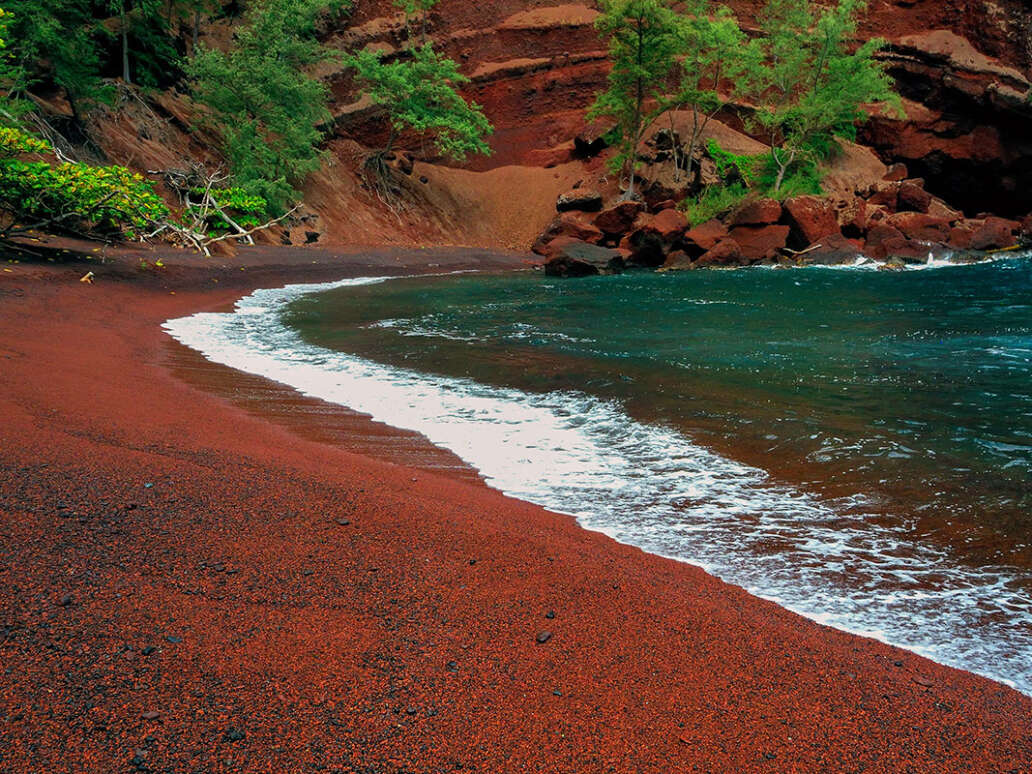 The vibrant red sand of Kaihalulu Bay.